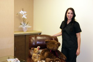 Photo: Amanda with stuffed animals in a chair at Encino CA Oral Surgery office